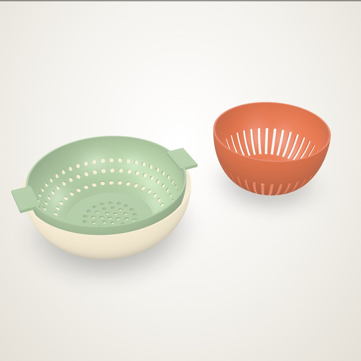 A sage fruit rinser basket with dots nested in a cream catch bowl, and a small terracotta basket with slots