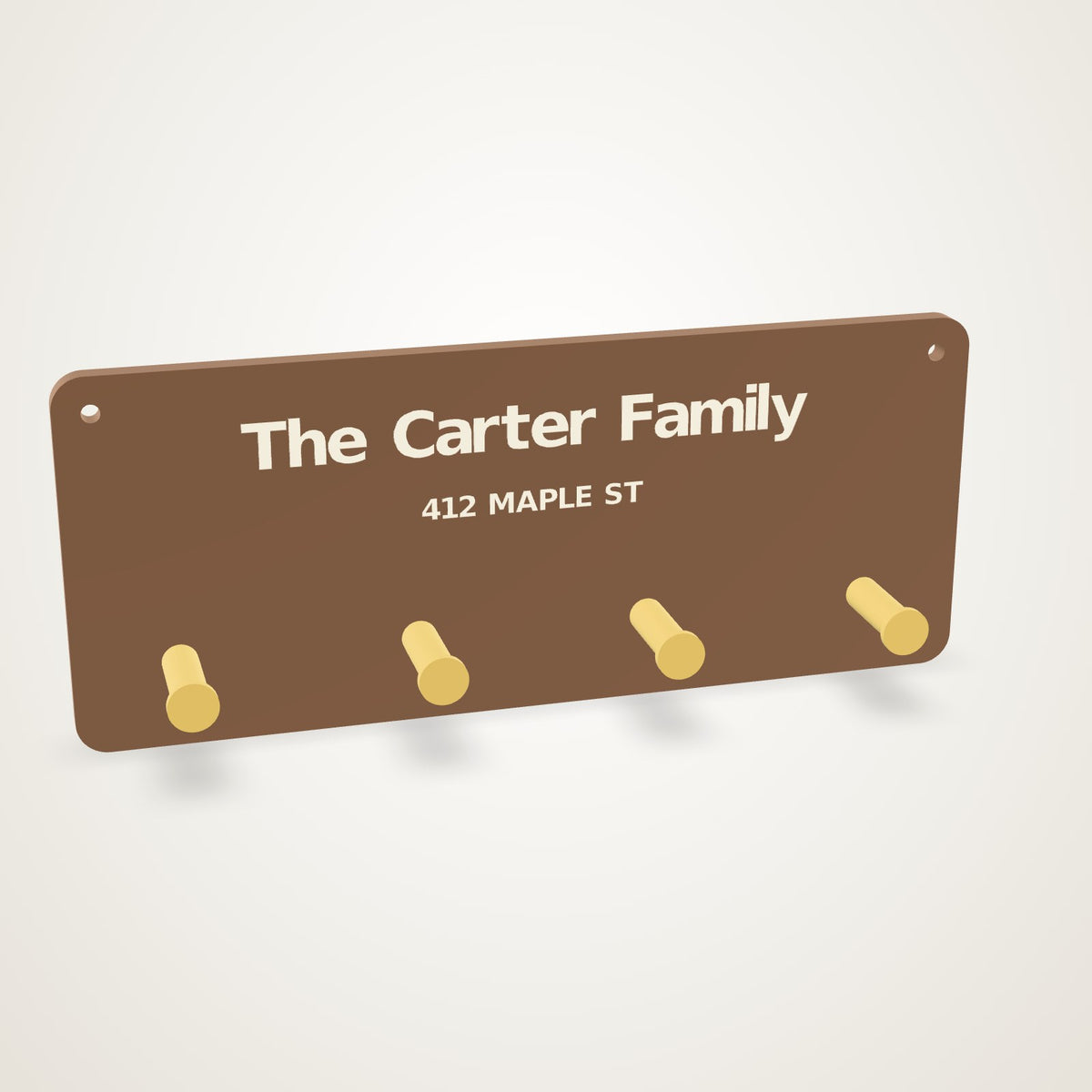 Anoor Keys Rack - walnut board with the family name inlaid in ivory, address beneath, four brass pegs